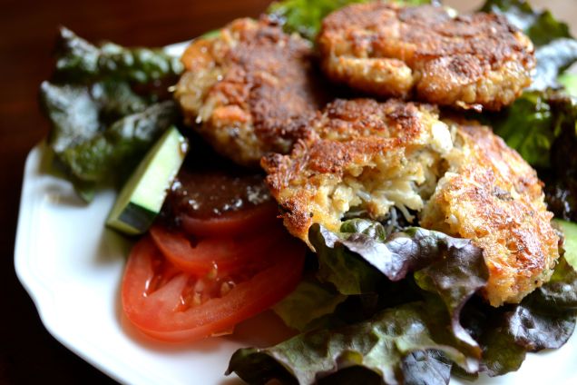 Crab cakes salad with sweet onion and poppyseed dressing.